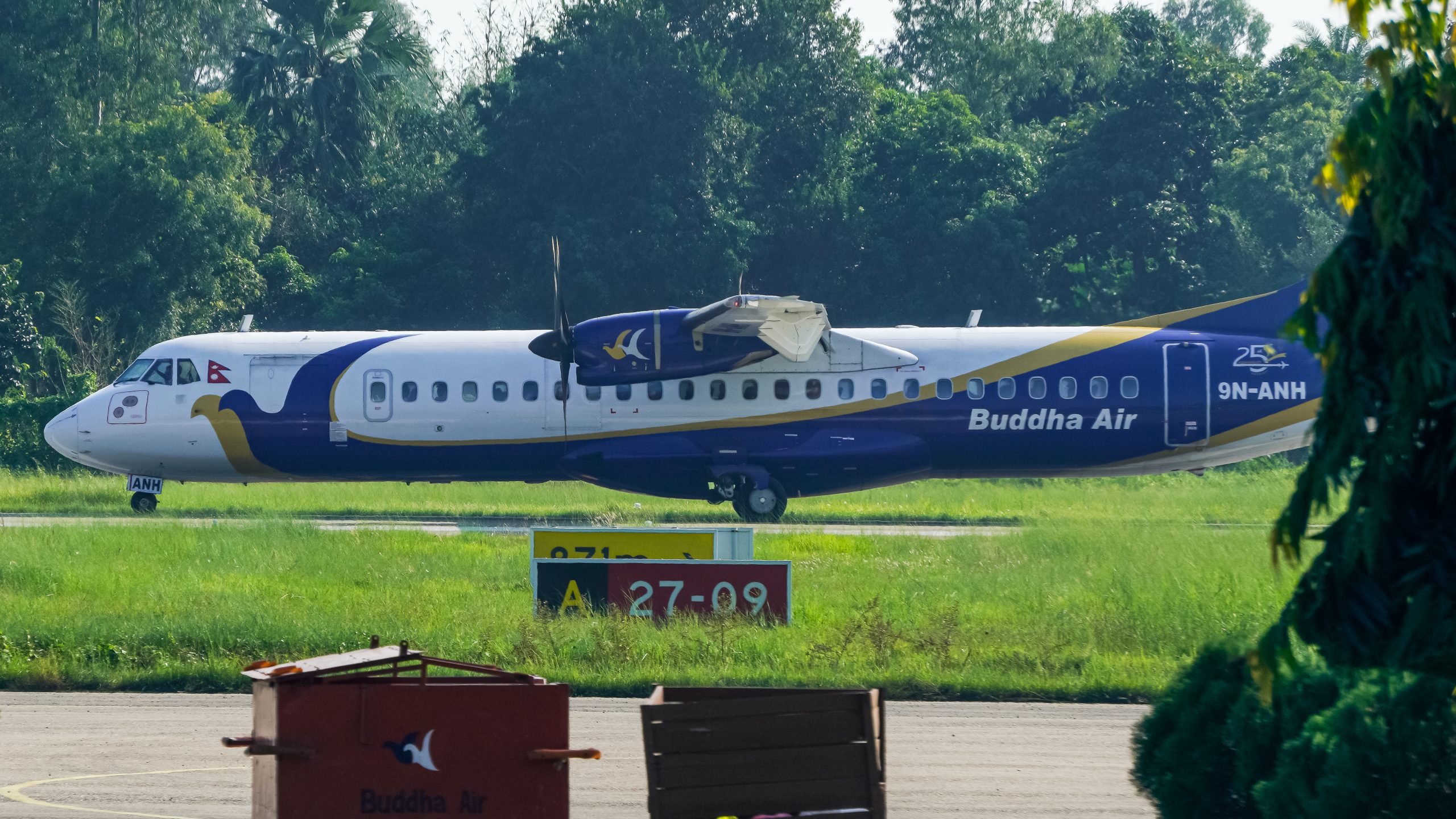 ATR 72-500 aircraft 9N-ANH of Buddha Air landing on runway during daylight.